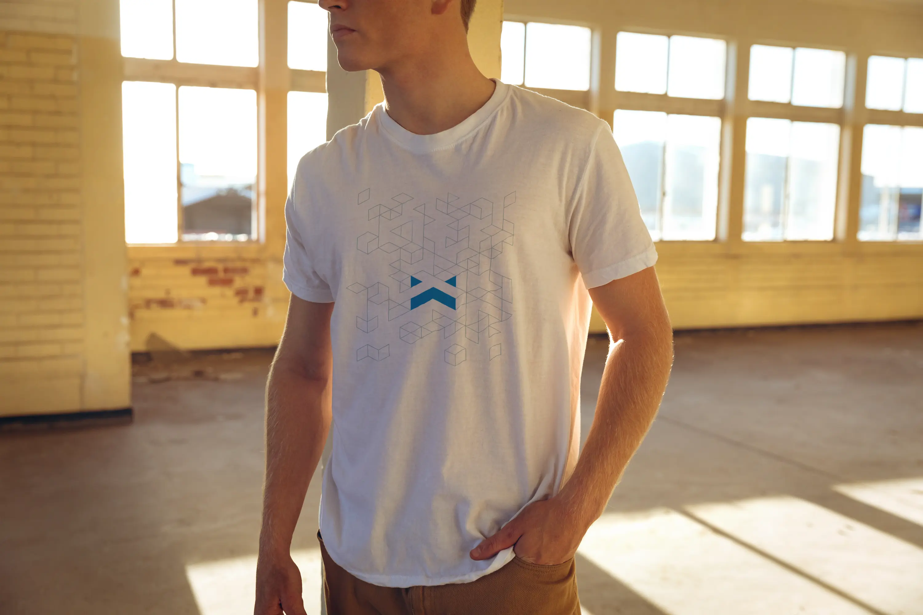 Person wearing white t-shirt with FLX Websites geometric logo design